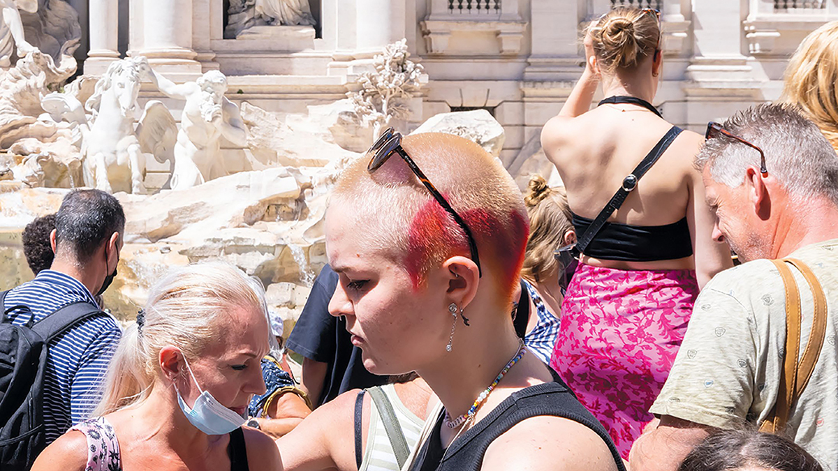Publications - Magazine - Spring 2023 detail of a magazine cover showing a punk girl with light skin and others standing in front of the Trevi Fountain in Rome