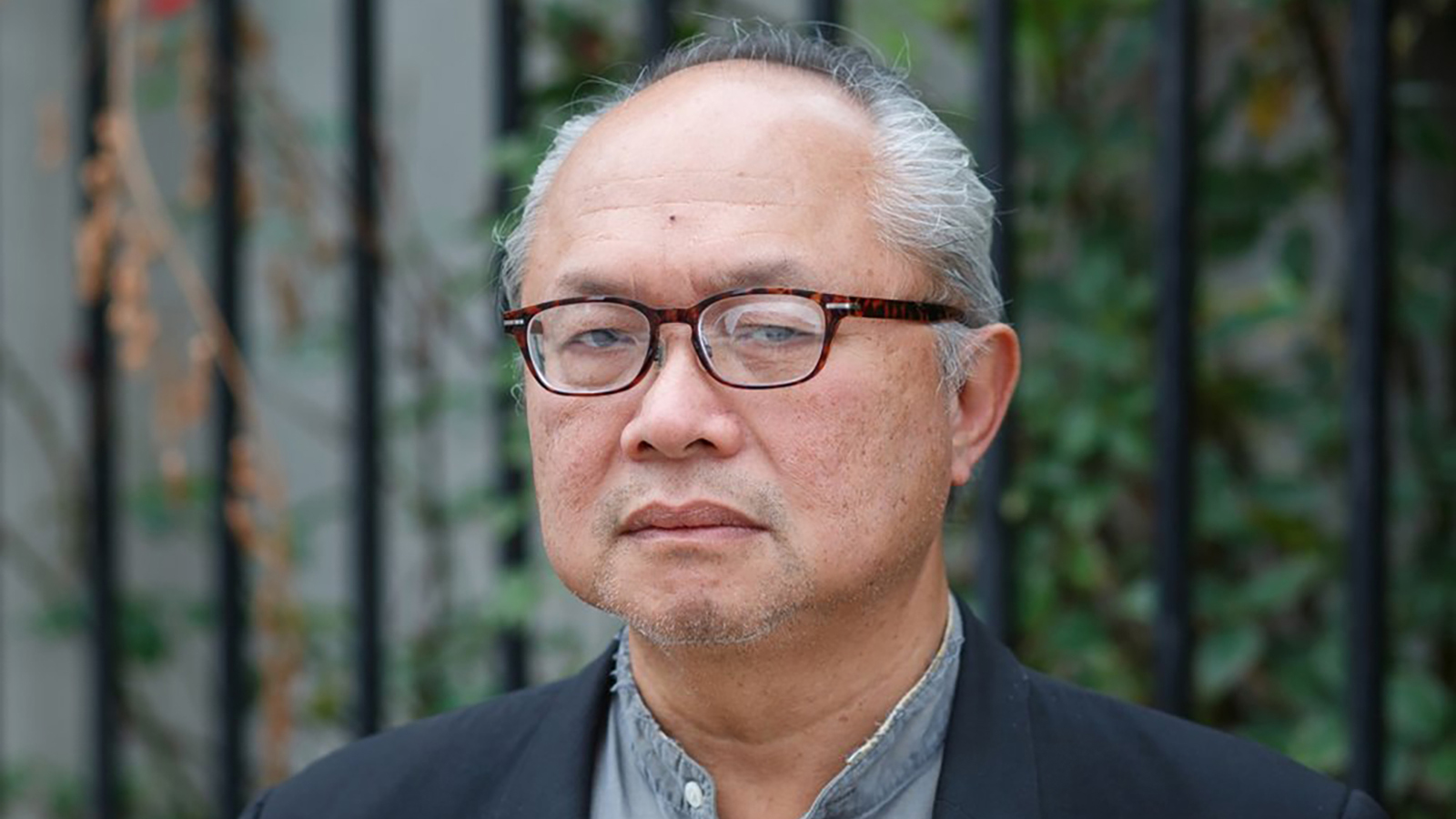Mel Chin Color photograph of an older Asian man wearing glasses