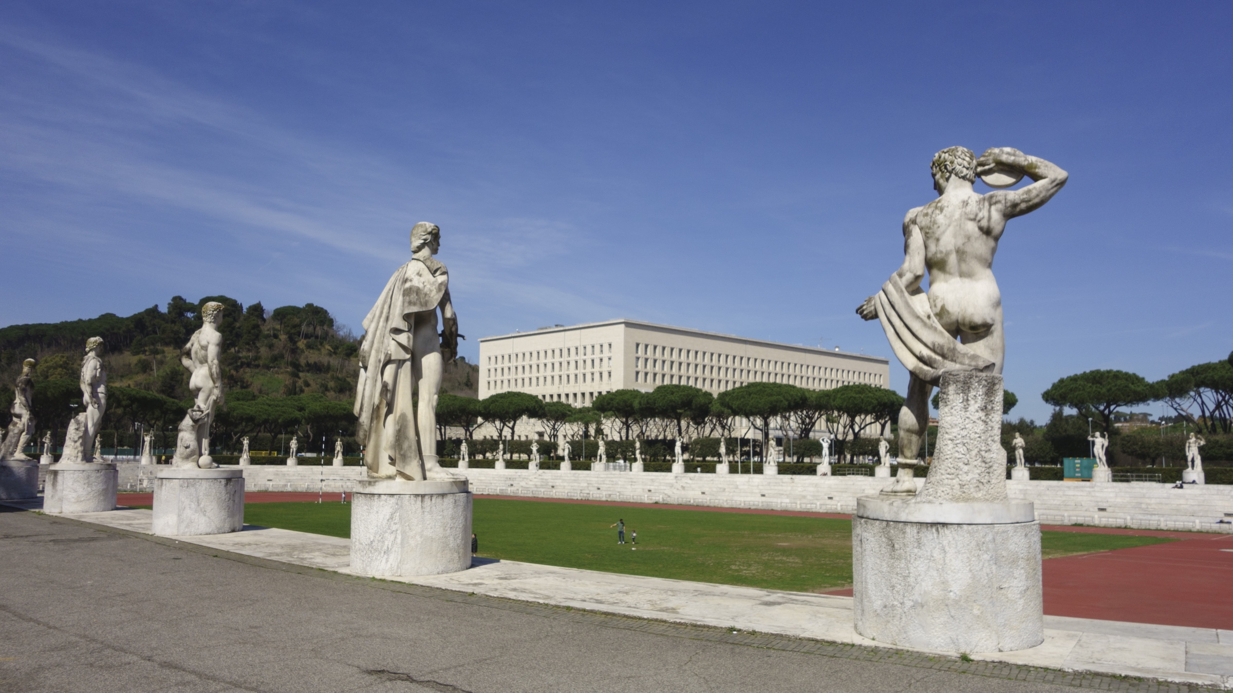 Four large statues of athletic youths at a Fascist sports stadium