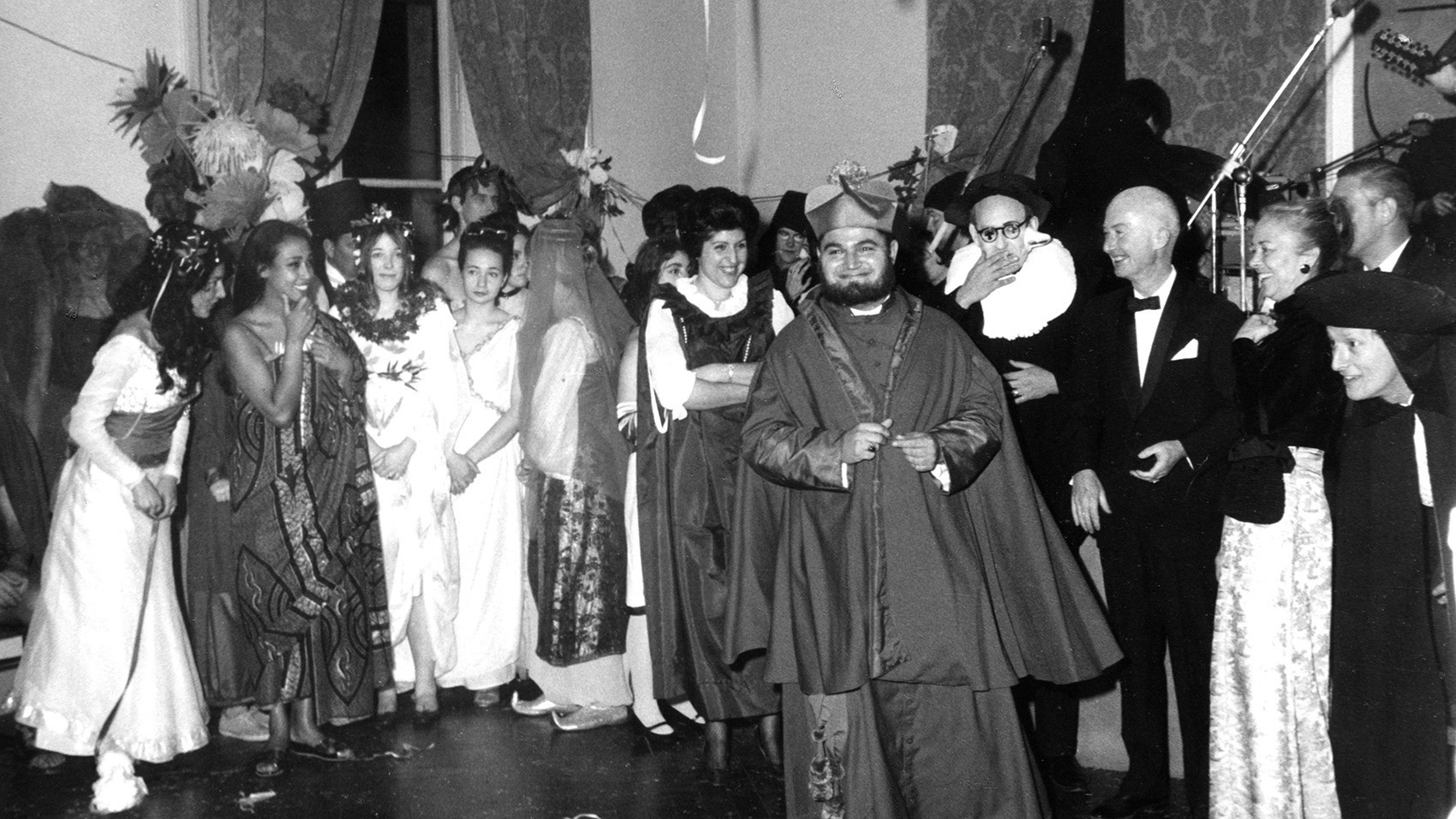 Black and white photographs of people at a party wearing costumes