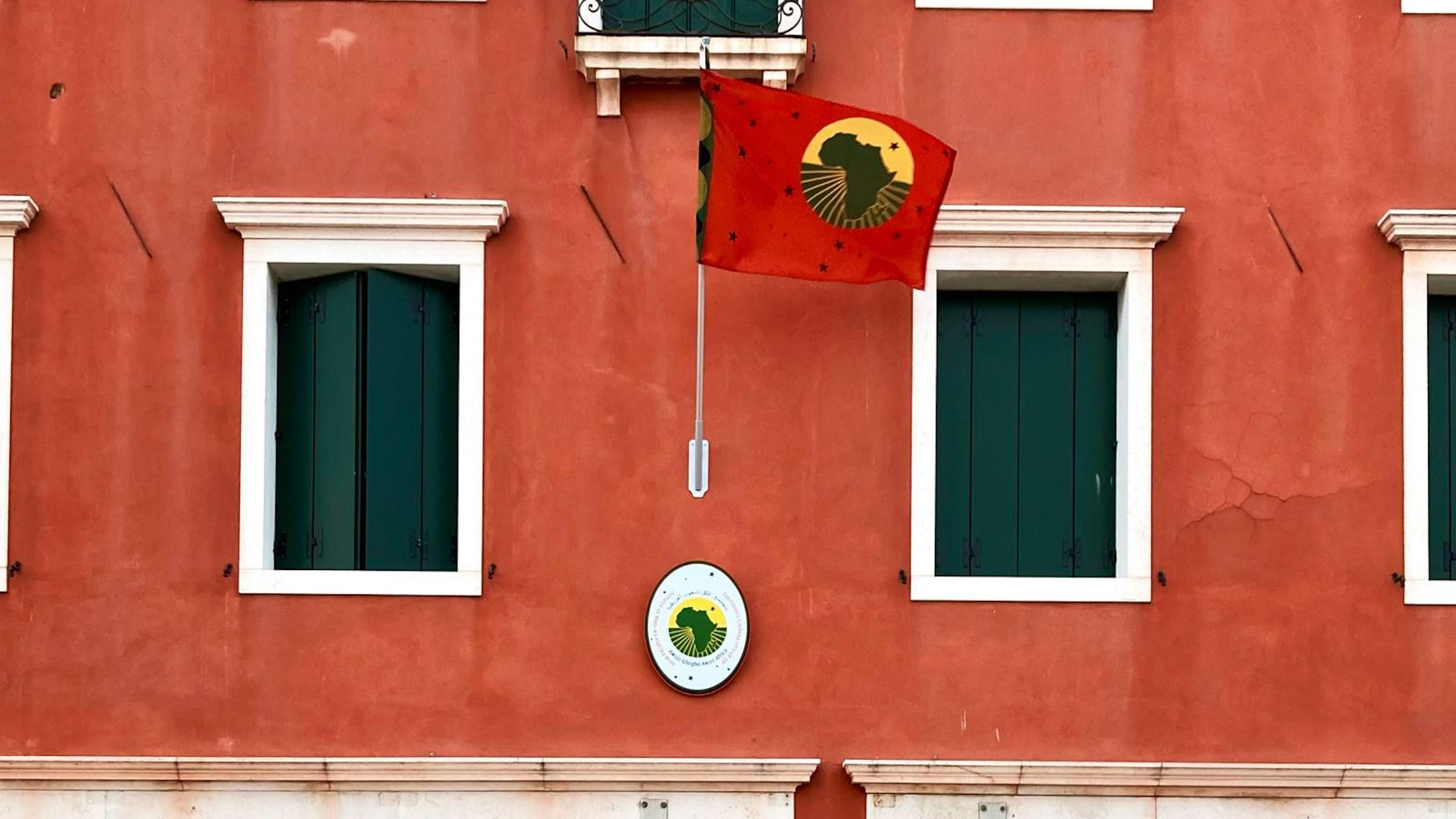 A red building with a red flag shown