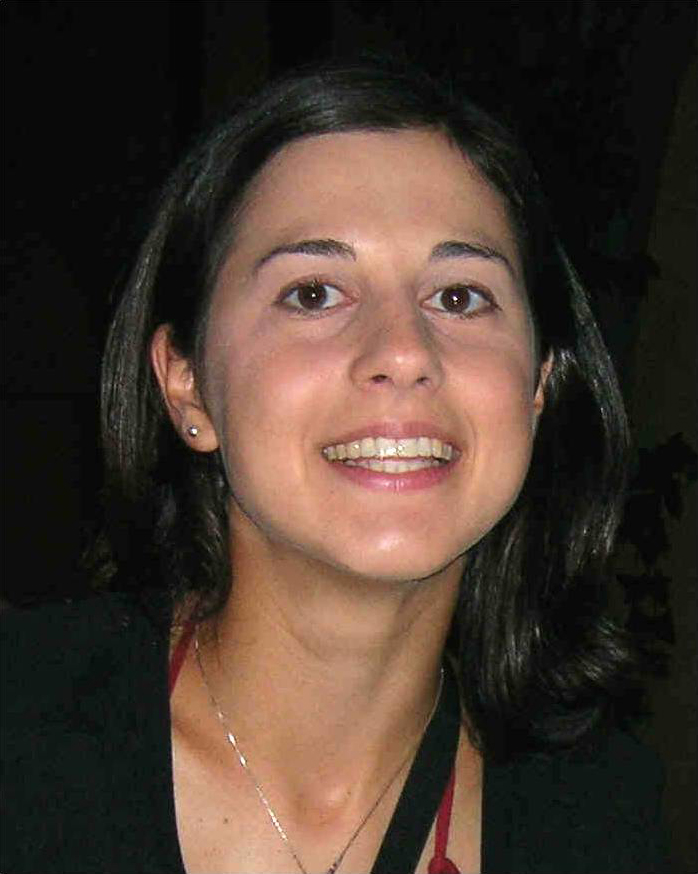 Darian Totten Color photo of the face and neck of a smiling light skinned woman with dark hair