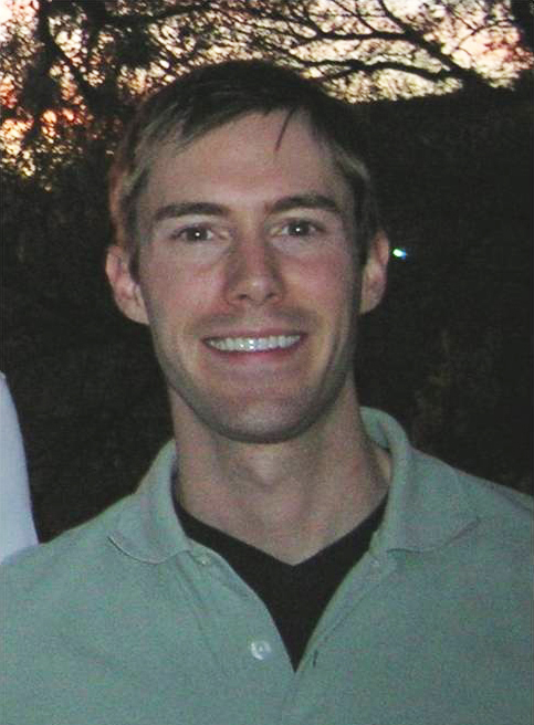 John N. N. Hopkins Color photograph of the head and torso of a light skinned man wearing a green polo shirt and smiling at the camera