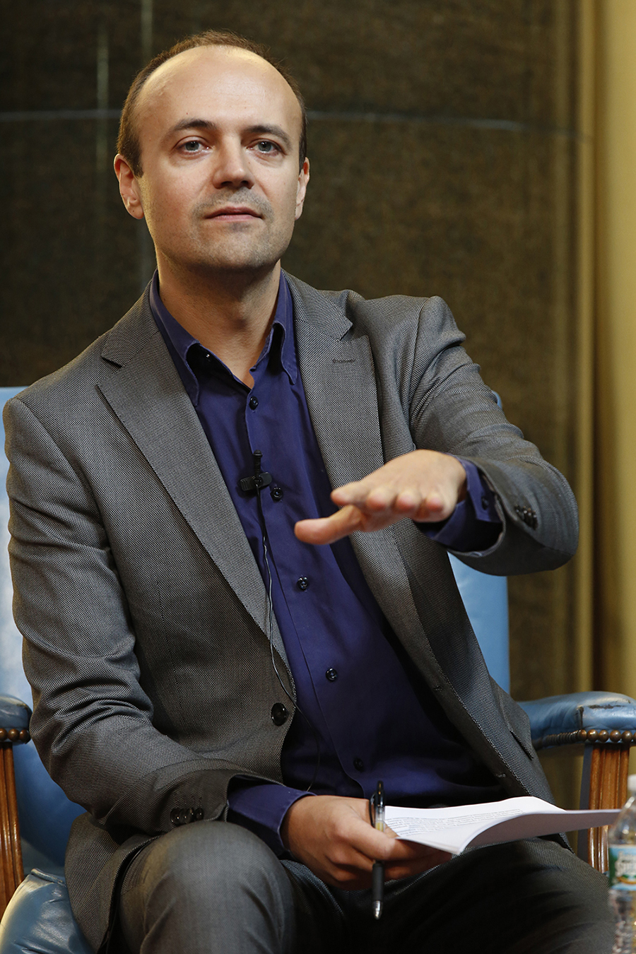 Color photograph of Jorge Otero-Pailos seated on a dais as part of an academic panel
