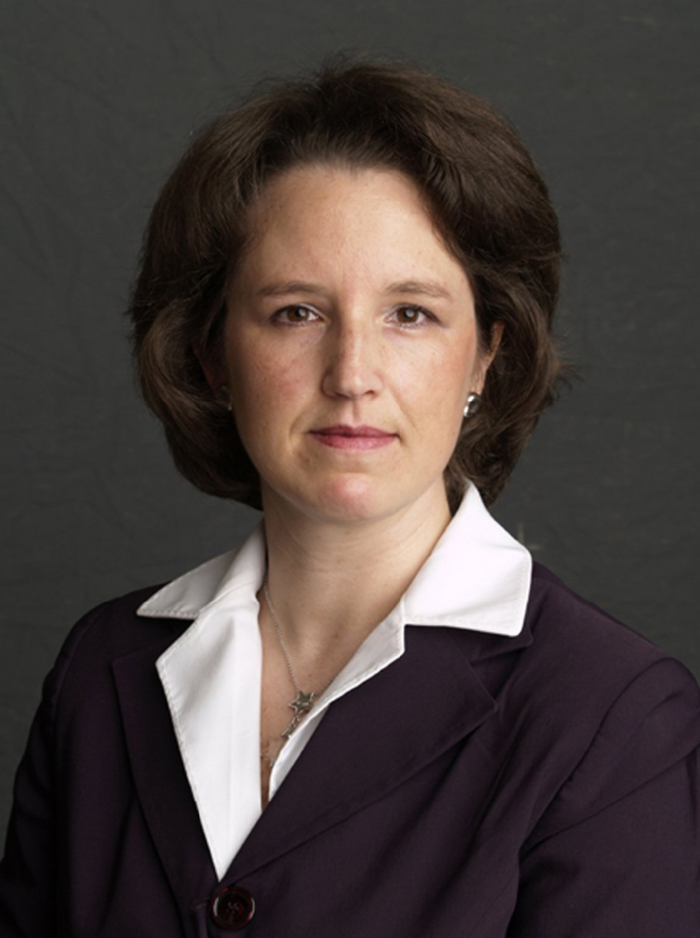 Meisha Hunter Color photograph of the head and shoulders of a light skinned woman with brown hair, looking at the camera