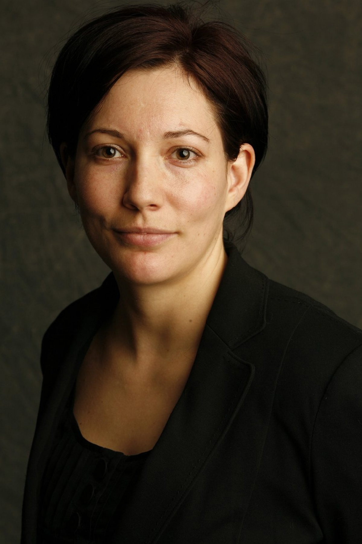 Rachel Van Dusen Color photograph of the head and shoulders of a light skinned woman with short brown hair