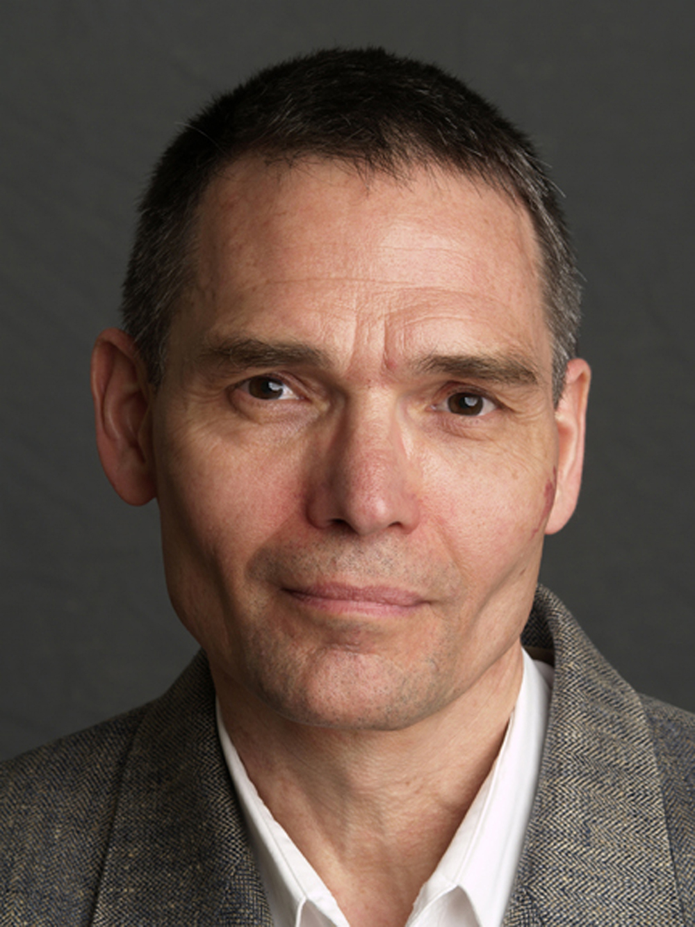 Richard Rezac Color photo of the face of a light skinned man smiling slightly at the camera