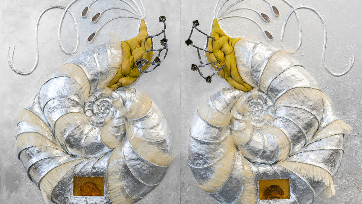 Detail of a silver and yellow wall relief depicting two enantiomorphic shells