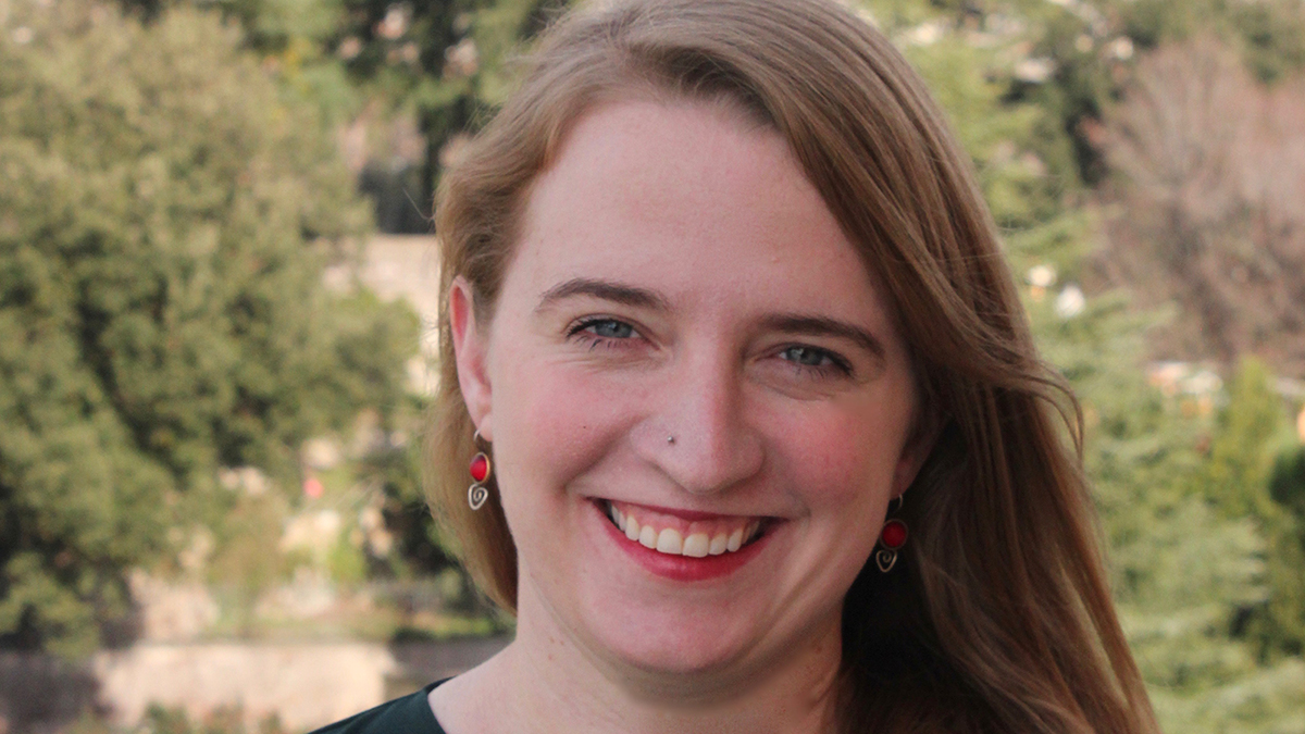 Color photograph of the head of Catherine Bonesho in an outdoor, natural location