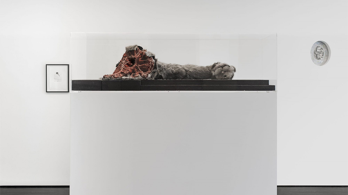 Color photo of an abstract sculpture resting on a white plinth