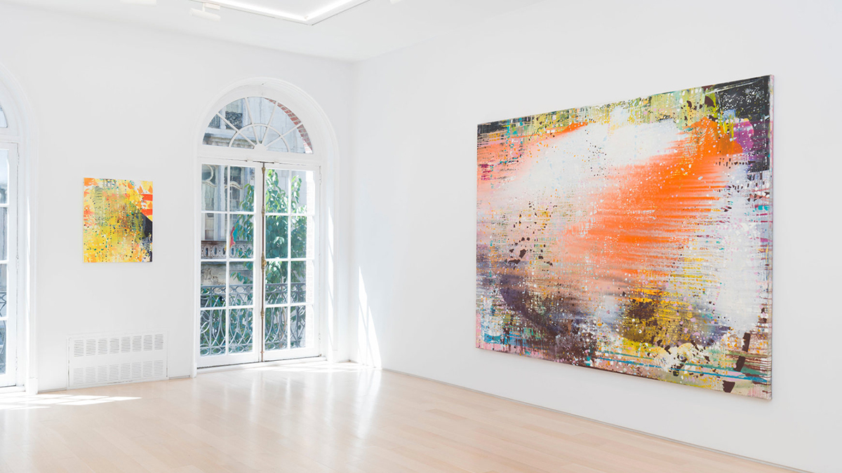 Color photograph of a townhouse gallery showing two abstract paintings on perpendicular walls between a window