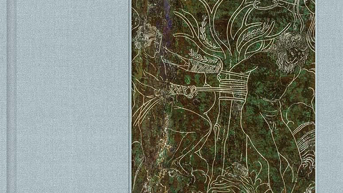 Detail of a book cover showing cloth binding material and a sliver of a roman incised drawing