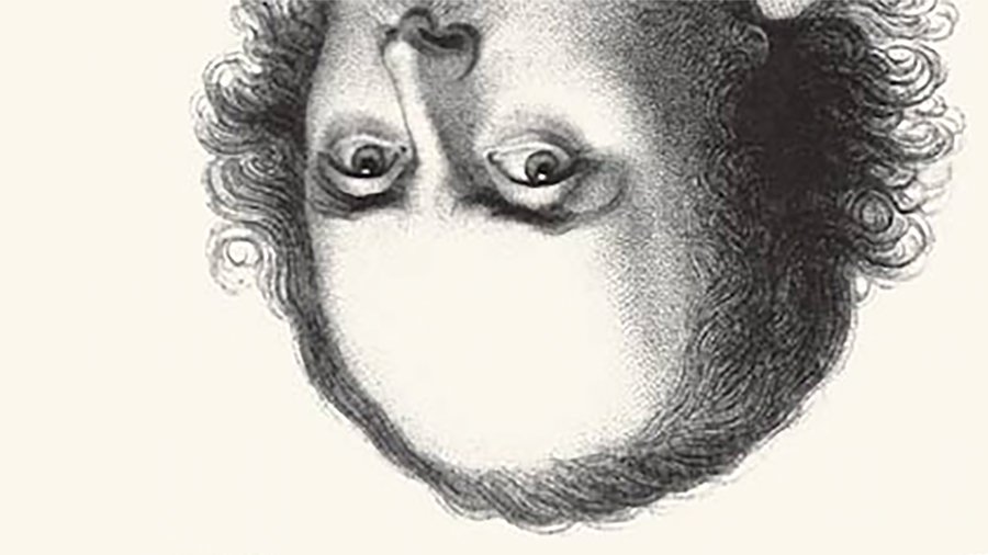 Detail of a book cover with an upside down engraving of Shakespeare from the nose up