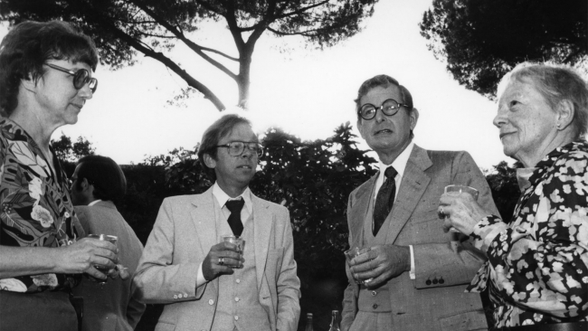 Black and white photograph of two men and two women at a garden party in Rome in 1980